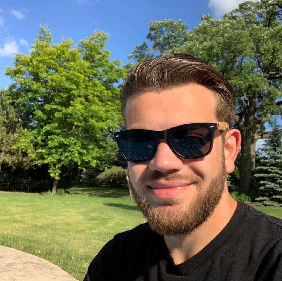 Ryan Salva wearing sunglasses while taking a selfie